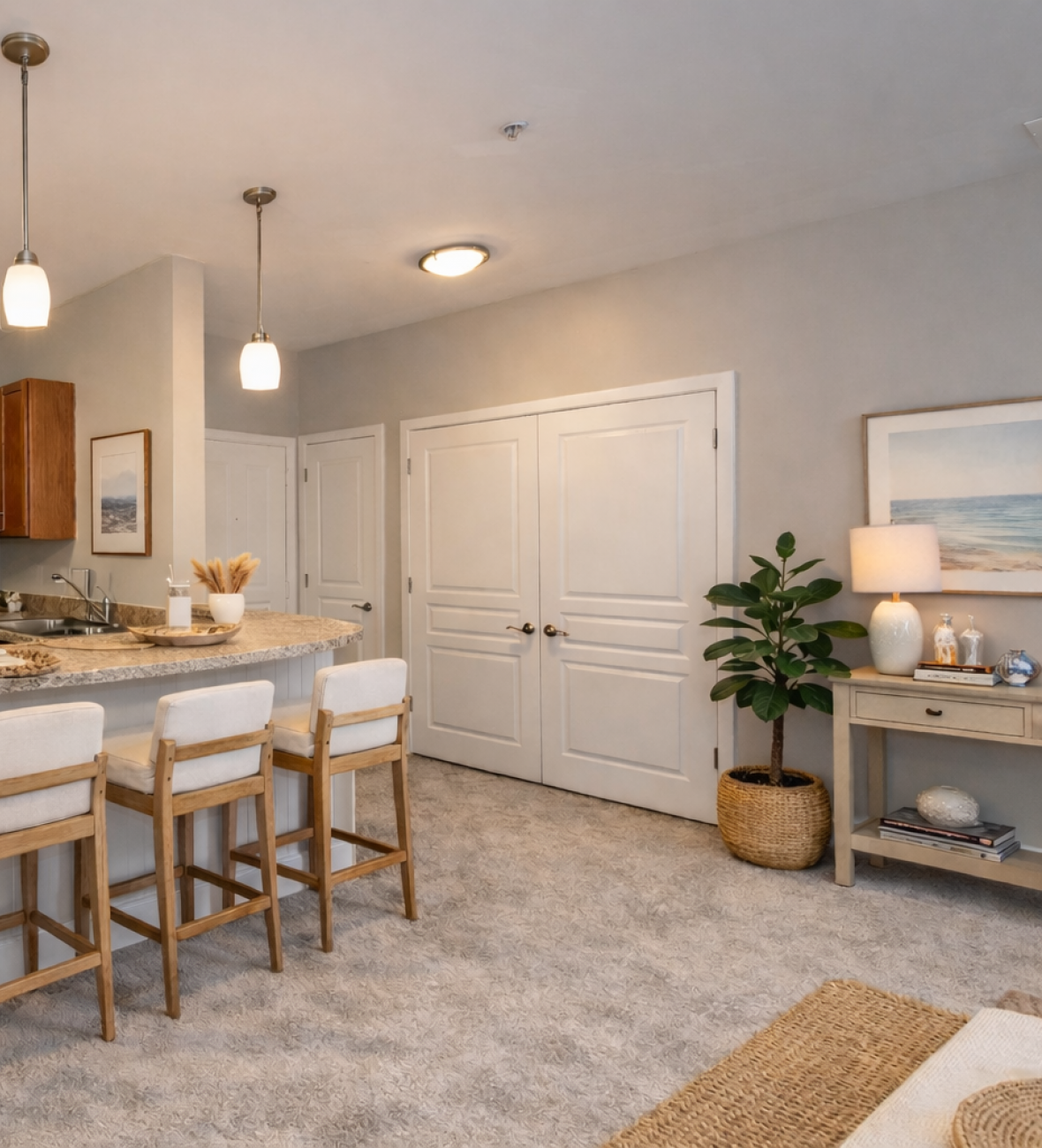 Modern kitchen with wood cabinets, stainless steel appliances, and a breakfast bar with three cushioned stools.